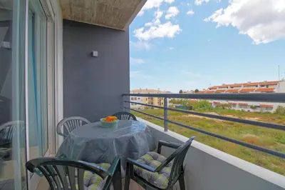a table and chairs on a balcony with a view at AlbufeiraMar Beach Apartment in Albufeira