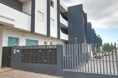a building with a gate and a fence at AlbufeiraMar Beach Apartment in Albufeira