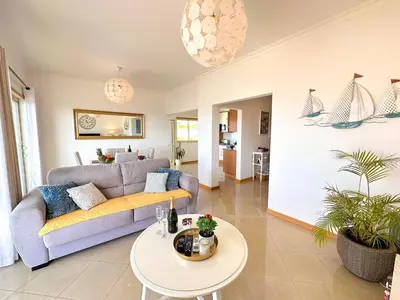 a living room with a couch and a table at AlbufeiraOrada Gloaming by Be Cherish in Albufeira