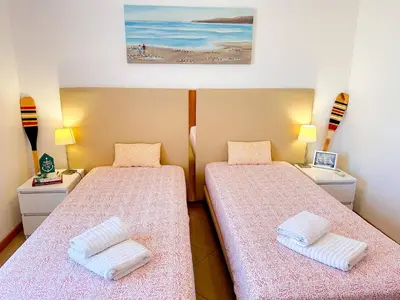 a room with two beds with pink sheets at AlbufeiraOrada Gloaming by Be Cherish in Albufeira
