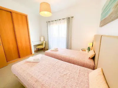 a hotel room with two beds and a desk at AlbufeiraOrada Gloaming by Be Cherish in Albufeira