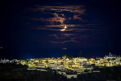 a view of a city at night with the moon at AlbufeiraOrada Gloaming by Be Cherish in Albufeira