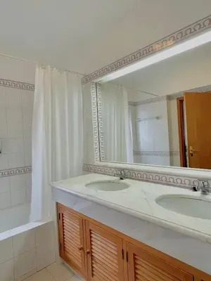 a bathroom with two sinks and a large mirror at Quinta do Lago Villa and Golf in Quinta do Lago