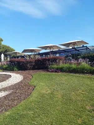 a park with a building with umbrellas in the background at Quinta do Lago Villa and Golf in Quinta do Lago