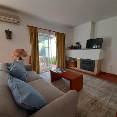 a living room with a couch and a fireplace at Quinta do Lago Villa and Golf in Quinta do Lago