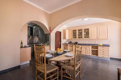 a kitchen with a table and chairs in a room at Casa Santa Maria in Boliqueime