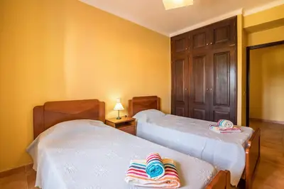 a room with two beds with towels on them at Casa Santa Maria in Boliqueime