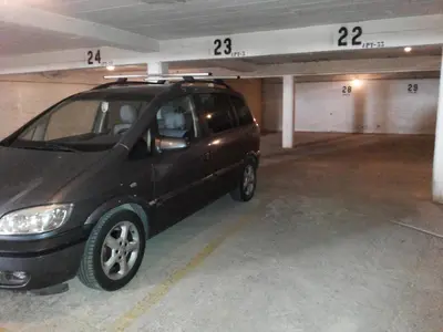 a small car parked in a parking garage at Regueiró Quarteira Beach Apartment in Quarteira