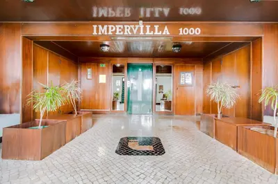 an entrance to a building with a sign that reads imperililla at AL - Apartamento 1021 Impervilla in Quarteira