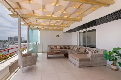 a living room with a couch and a table at Marina Vilamoura Penthouse Luxury in Vilamoura
