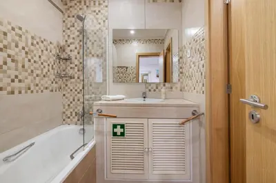 a hotel room with two beds and a desk at Marina Vilamoura Penthouse Luxury in Vilamoura