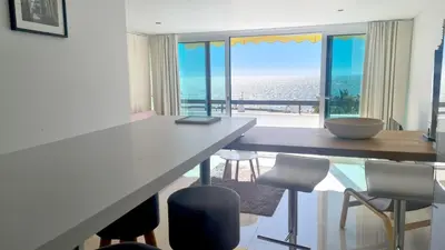 a dining room with a table and a view of the ocean at Beach lovers apartment 26 in Albufeira