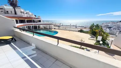 a balcony with a swimming pool and the ocean at Beach lovers apartment 26 in Albufeira