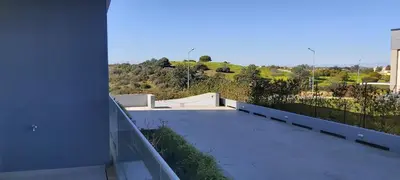 a balcony of a house with a view of a hill at Albufeira beach apartment in Albufeira