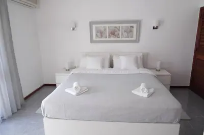 a bedroom with a large white bed and a window at Happy House-fantastic holiday with all amenities in Albufeira
