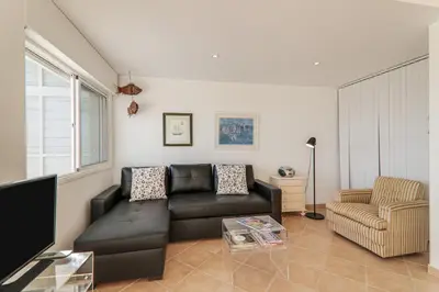 a room with a balcony with a view of the ocean at Sail Away in Quarteira