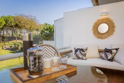 a living room with a couch and a table at M&M Home in Quinta do Lago