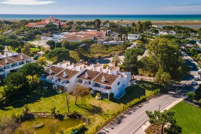 an aerial view of a house with the ocean in the background at M&M Home in Quinta do Lago