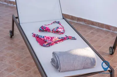 a table with a towel and a pair of glasses at Vila Nico by MTPhomes in Albufeira