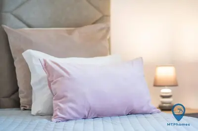 a bed with a bunch of pillows on it at Vila Nico by MTPhomes in Albufeira