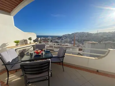 a table and chairs on a balcony with a view at Apartamento Varandas do Mar in Albufeira