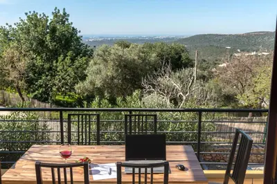 a table and chairs on a balcony with a view at Sunny House in Loulé