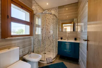 a bathroom with a shower and a toilet and a sink at Sunny House in Loulé