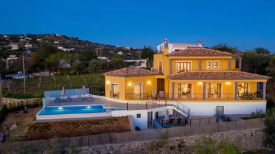 a large yellow house with a swimming pool at Sunny House in Loulé