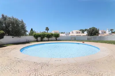a large swimming pool in the middle of a yard at Casa O12 in Vilamoura