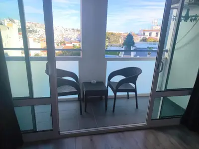 a balcony with a view of a swimming pool on a building at Bay View Old Town Apartments in Albufeira