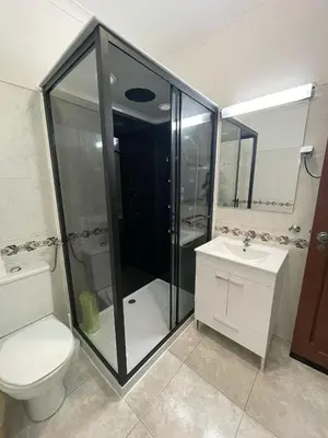 a bathroom with a shower and a toilet and a sink at cantinho do mar in Albufeira