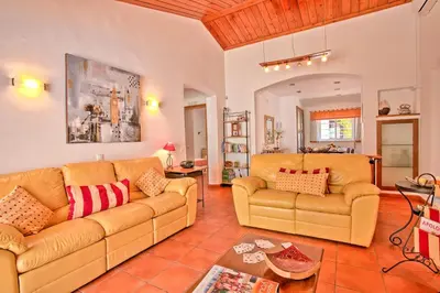 a living room with two couches and a table at Villa Dela by Villa Plus in Albufeira