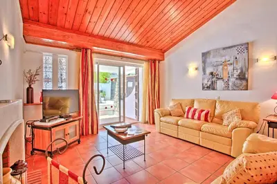 a living room with a couch and a tv at Villa Dela by Villa Plus in Albufeira