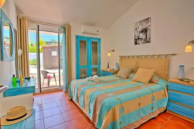 a bedroom with a bed and a balcony at Villa Dela by Villa Plus in Albufeira