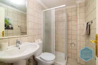 a bathroom with a sink and a toilet and a shower at Falésia Park - Dream Lodging in Albufeira