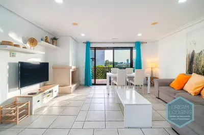 a living room with a couch and a tv at Falésia Park - Dream Lodging in Albufeira