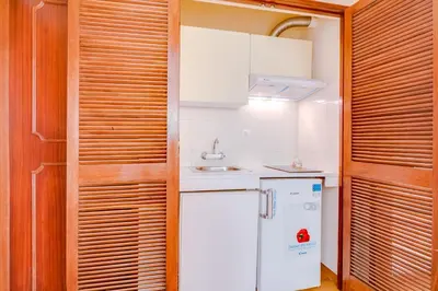a kitchen with a white refrigerator and a sink at LovelyStay - Villa Mimi in Vilamoura