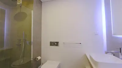 a bathroom with a shower and a toilet and a sink at Marina Parque 211-CleverDetails, Located in the Marina, Private Pool in Vilamoura