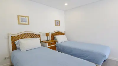 a bedroom with two beds and a night stand with a lamp at Marina Parque 211-CleverDetails, Located in the Marina, Private Pool in Vilamoura
