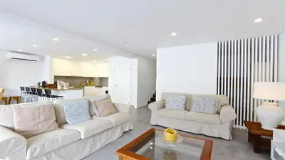 a living room with two white couches and a table at Marina Parque 211-CleverDetails, Located in the Marina, Private Pool in Vilamoura