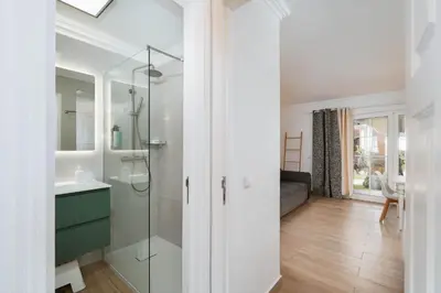 a bathroom with a glass shower and a sink at Sweet Old Village in Quarteira