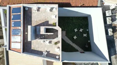 an aerial view of a building with a yard at THE MODERNIST, Architecture experience in Faro