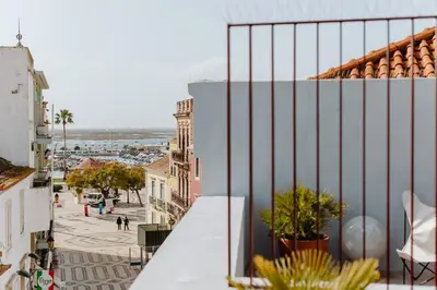 a view of a city from the balcony of a building at THE MODERNIST, Architecture experience in Faro