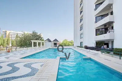 a swimming pool in front of a building at Vilamoura Marina Extraordinary 70 m2 T1, Marina 200m , beach 300m in Vilamoura