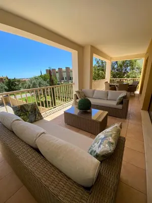 a large living room with couches and a balcony at J&J Home T2 next to Pinhal Velho, Terraces of Pinhal, Vilamoura in Quarteira