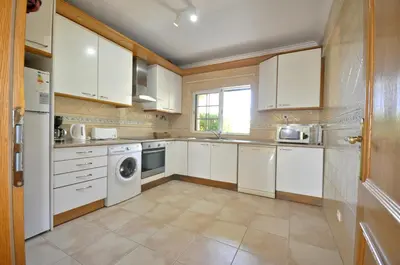 a yard with palm trees and a patio at A stylish villa with a private pool, short drive from the centre, free AC Wifi in Quarteira