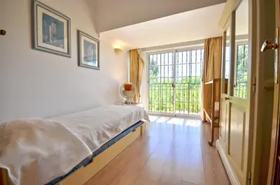 a room with two beds and a window at A stylish villa with a private pool, short drive from the centre, free AC Wifi in Quarteira