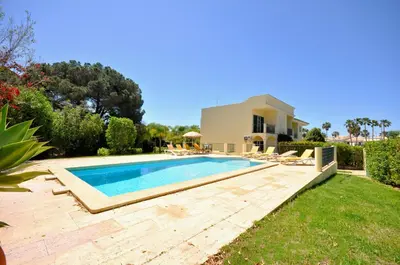 a swimming pool in the yard of a house at A stylish villa with a private pool, short drive from the centre, free AC Wifi in Quarteira