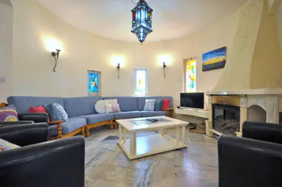a kitchen with a white refrigerator and wooden cabinets at Spacious Retreat with Prime Location, Private pool, snooker, free AC Wifi in Quarteira