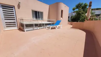 a patio with a table and chairs and a swimming pool at Spacious Retreat with Prime Location, Private pool, snooker, free AC Wifi in Quarteira